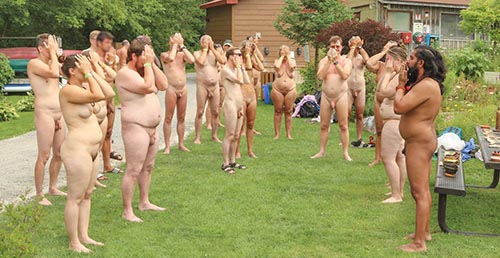 naked yoga group on a lawn