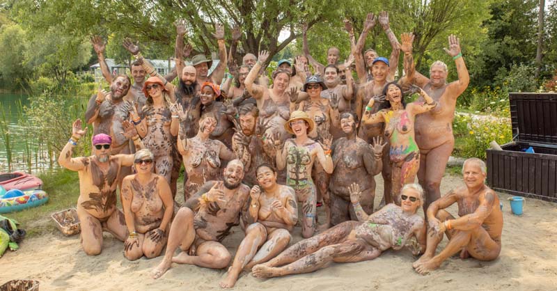 Bodyfest group photo with clay-covered bodies looking primative
