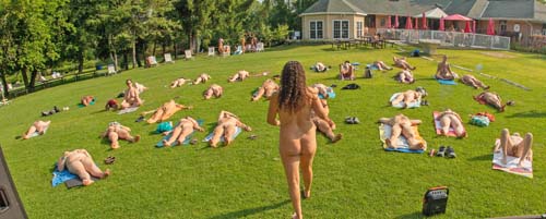 Yoga class all bodies lying on their backs on the Bare Oaks big lawn