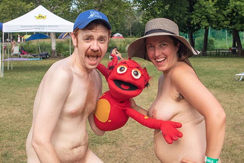 Two people with a hand puppet posing for camera